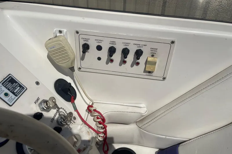 Slide: The Image of Control panel of a 1998 Fountain 29 Fever boat with switches and microphone. - 23