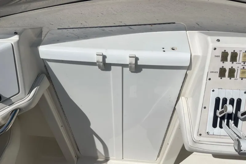 Slide: The Image of Control panel of a 1998 Fountain 29 Fever boat, featuring switches and levers. - 25