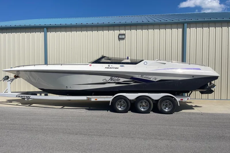 Slide: The Image of 1998 Fountain 29 Fever speedboat on trailer, parked outside a metal building. - 30