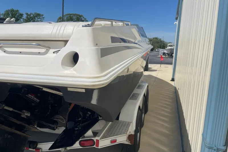 Slide: The Image of 1998 Fountain 29 Fever boat on trailer beside a building. - 4