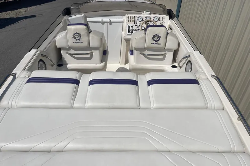 Slide: The Image of 1998 Fountain 29 Fever boat interior with white and blue seating. - 6