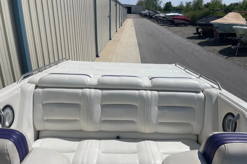 Slide: The Image of 1998 Fountain 29 Fever boat with white seating, parked near storage facility. - 8