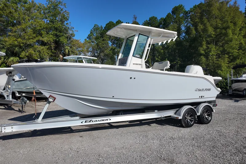 The Image of 2026 Sailfish 232 CC boat on EZ Loader trailer, parked outdoors. - 0