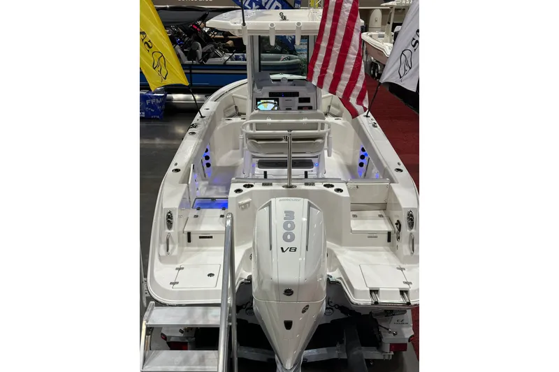 Slide: The Image of 2026 Sailfish 232 CC boat with V8 engine, American flag, and illuminated interior. - 10