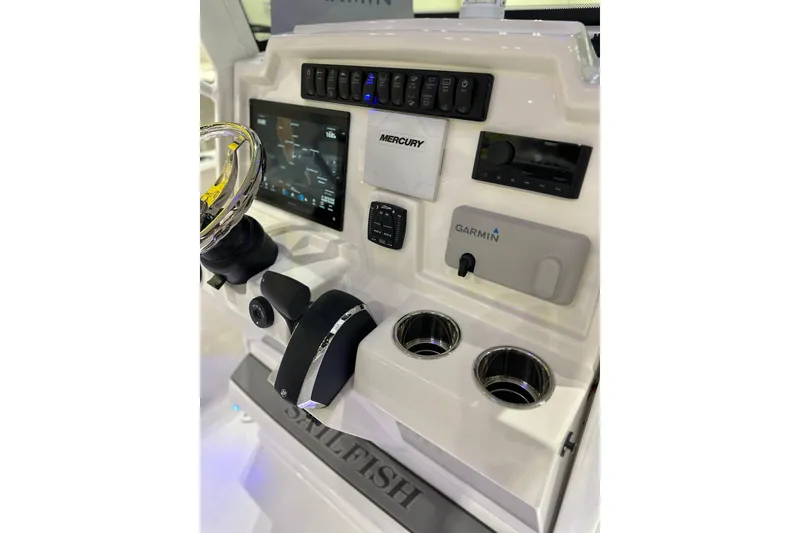 Slide: The Image of 2026 Sailfish 232 CC boat dashboard with Garmin and Mercury controls. - 11