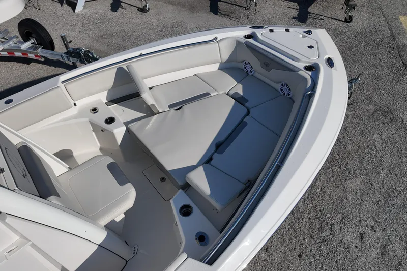 Slide: The Image of 2026 Sailfish 232 CC boat interior with cushioned seating and cup holders. - 5