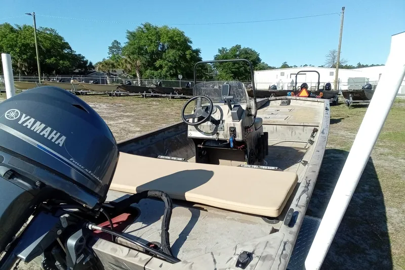 Slide: The Image of 2015 SeaArk 170 RX boat with Yamaha outboard motor, parked outdoors. - 13