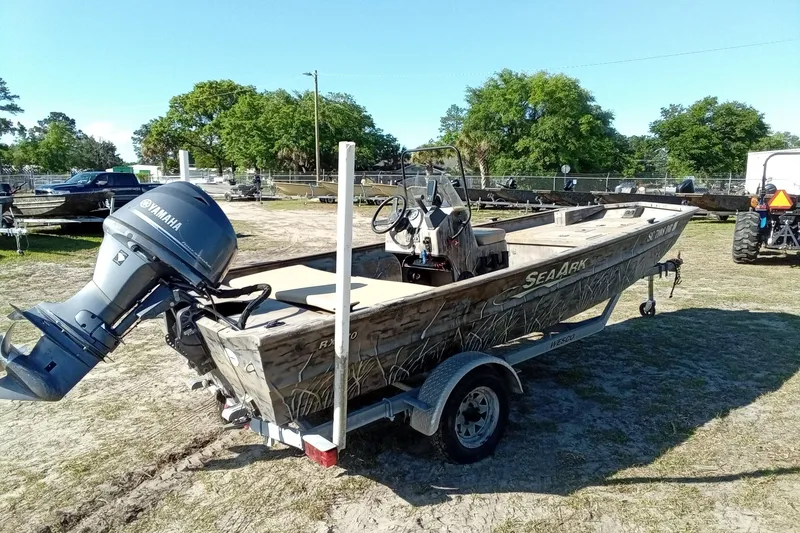 Slide: The Image of 2015 SeaArk 170 RX boat with Yamaha motor on trailer, parked outdoors. - 14