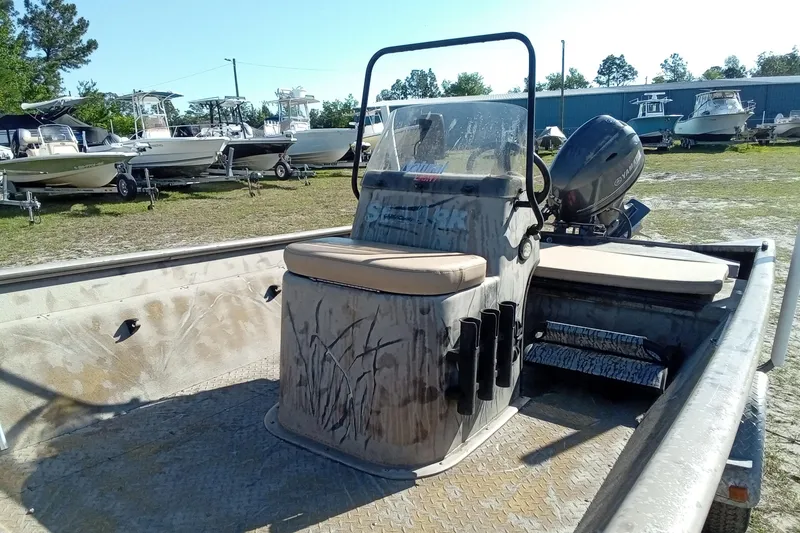 Slide: The Image of 2015 SeaArk 170 RX boat with Yamaha motor, parked among other boats. - 8