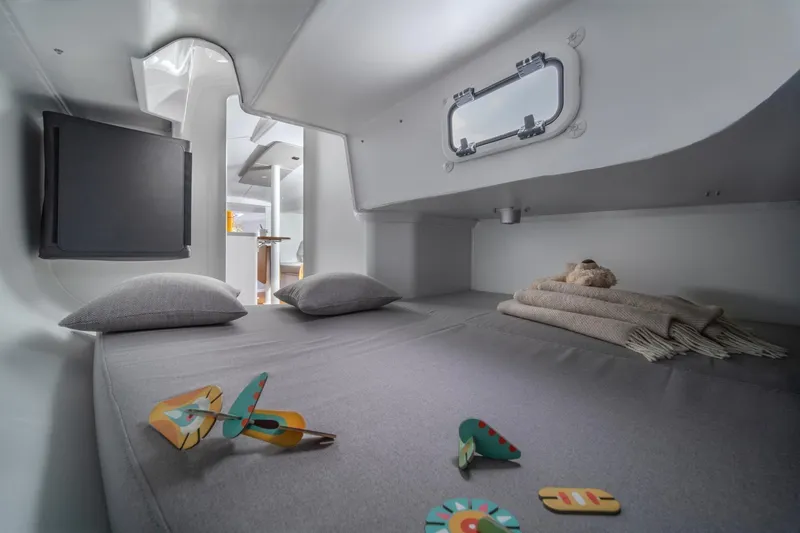 Slide: The Image of Cozy cabin interior of 2026 Beneteau First 30 yacht with bed and porthole. - 4