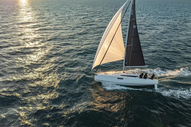 Slide: The Image of Sailing the ocean, 2026 Beneteau First 30 yacht glides gracefully at sunset. - 5