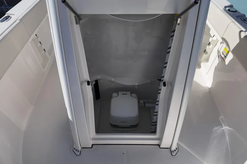 Slide: The Image of Interior view of 2026 Sailfish 232 CC boat's compact marine toilet compartment. - 10