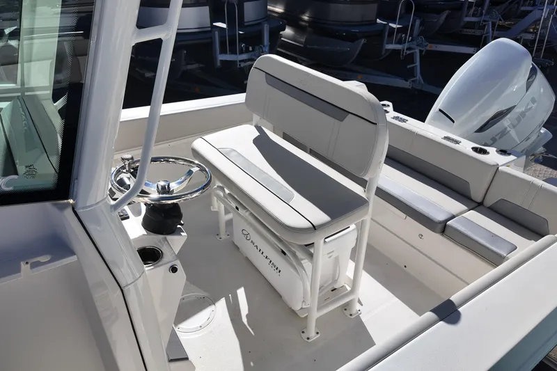 Slide: The Image of 2026 Sailfish 232 CC boat interior with steering wheel and seating. - 11