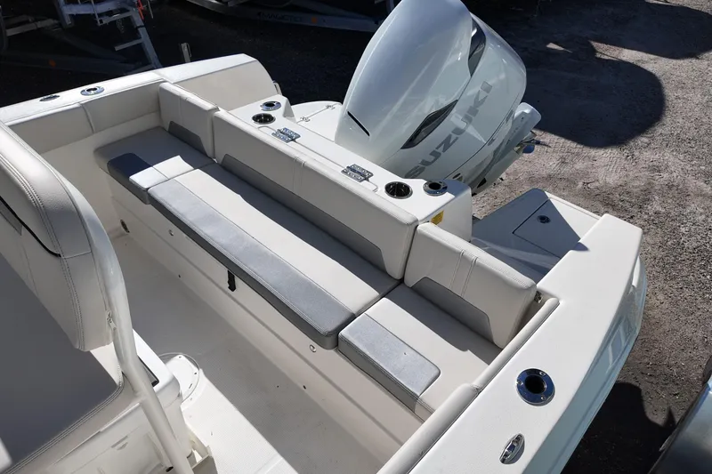 Slide: The Image of 2026 Sailfish 232 CC boat interior with seating and Suzuki outboard motor. - 12