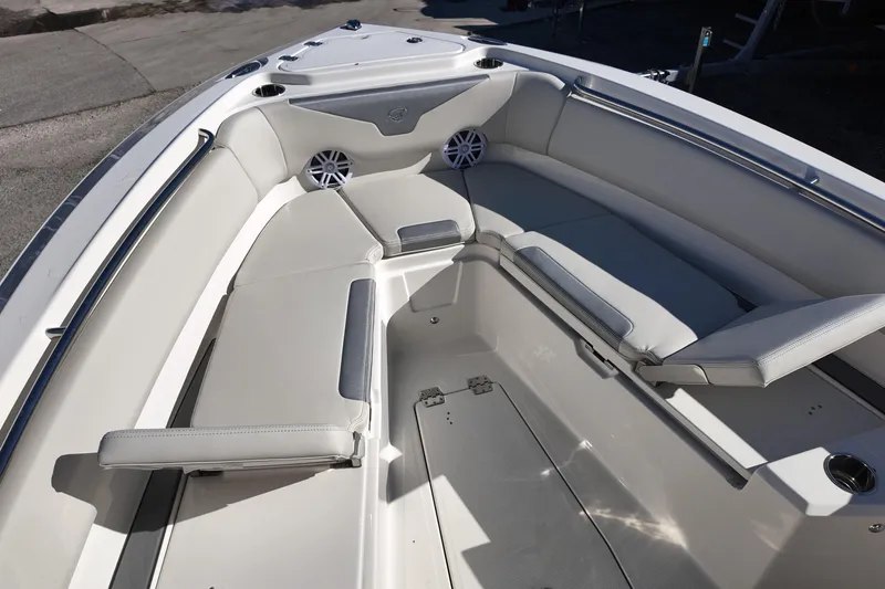 Slide: The Image of 2026 Sailfish 232 CC boat interior with cushioned seating and cup holders. - 8