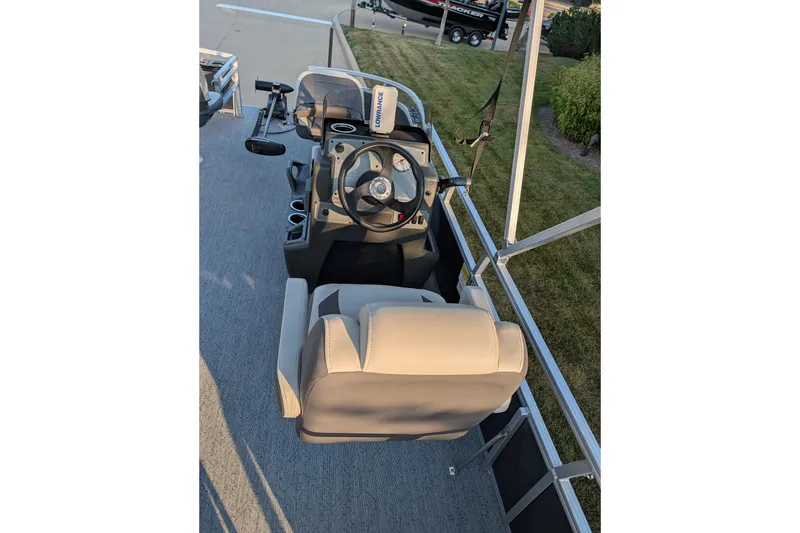 Slide: The Image of 2026 Sun Tracker Bass Buggy 16 XL Select boat interior with steering console and seating. - 4