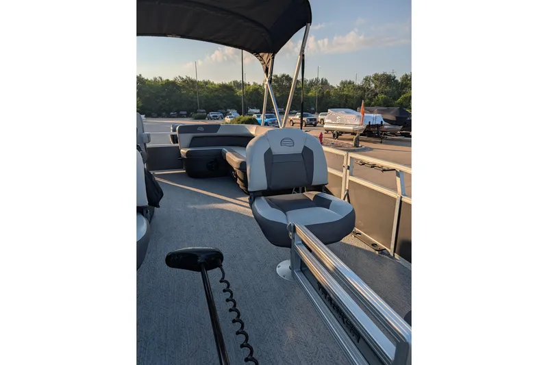Slide: The Image of 2026 Sun Tracker Bass Buggy 16 XL Select pontoon boat interior with seating and canopy. - 82