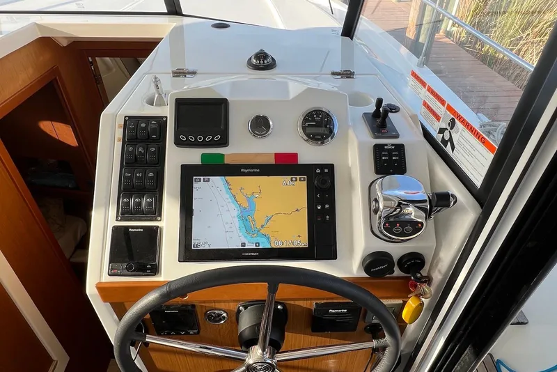 Slide: The Image of 2020 Beneteau Swift Trawler 35 helm with navigation controls and display screen. - 9