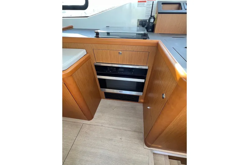 Slide: The Image of Interior of 2020 Beneteau Swift Trawler 35, featuring modern kitchen cabinetry and appliances. - 13