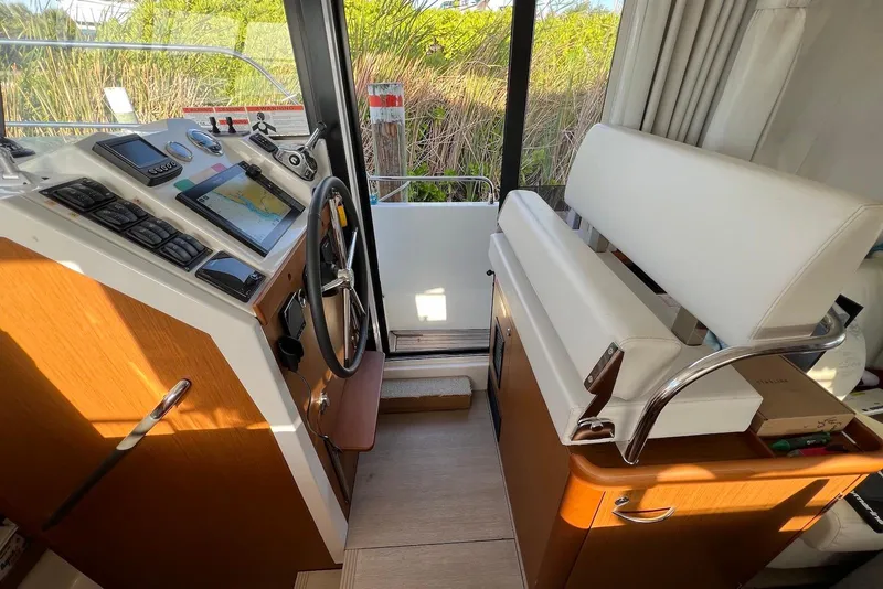 Slide: The Image of Interior helm of 2020 Beneteau Swift Trawler 35 with navigation equipment and seating. - 14