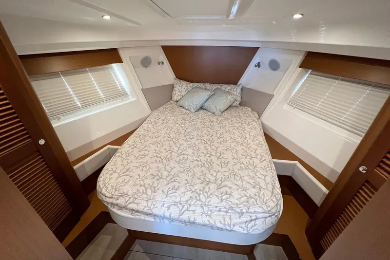 Slide: The Image of Cozy bedroom in 2020 Beneteau Swift Trawler 35 with elegant bedding and wooden accents. - 16