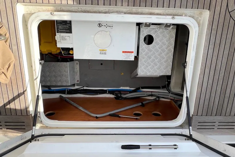 Slide: The Image of Engine compartment of a 2020 Beneteau Swift Trawler 35, showcasing internal components and wiring. - 23
