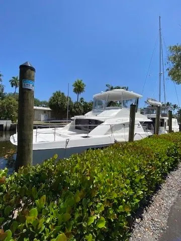 Slide: The Image of 2019 Leopard 43 PC yacht docked, sunny day, surrounded by greenery. - 39