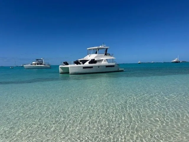 Slide: The Image of 2019 Leopard 43 PC yacht docked, sunny day, surrounded by greenery. - 43