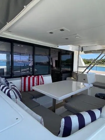 Slide: The Image of 2019 Leopard 43 PC yacht with stylish outdoor seating and striped cushions. - 9