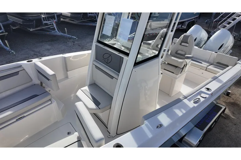 Slide: The Image of 2026 Sailfish 252 CC boat interior with seating and console, showcasing modern design. - 10