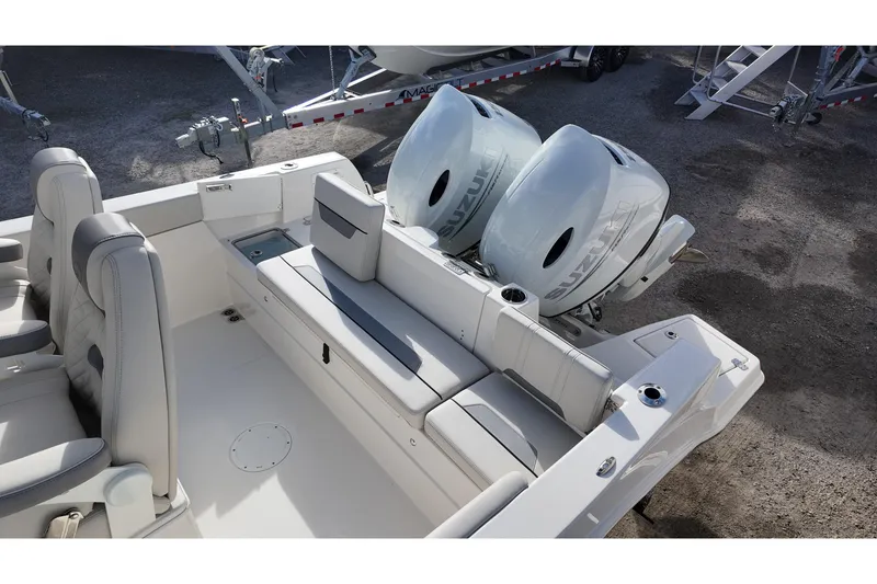 Slide: The Image of 2026 Sailfish 252 CC boat interior with dual Suzuki outboard engines and comfortable seating. - 12