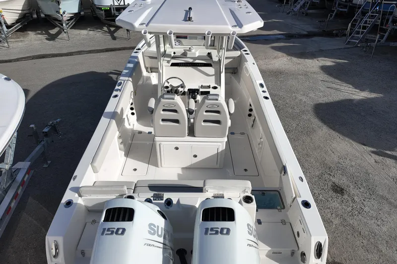 Slide: The Image of 2026 Sailfish 252 CC boat with dual Suzuki 150 engines, spacious deck, and modern helm. - 13