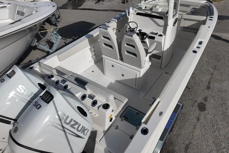Slide: The Image of 2026 Sailfish 252 CC boat with dual Suzuki 150 engines, spacious deck, and modern controls. - 4