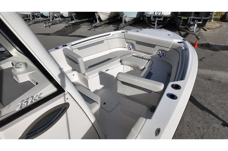 Slide: The Image of 2026 Sailfish 252 CC boat interior with cushioned seating and cup holders. - 7