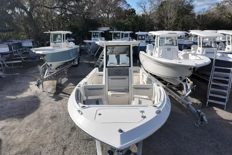 Slide: The Image of 2026 Sailfish 252 CC boats displayed on trailers in a dealership lot. - 8