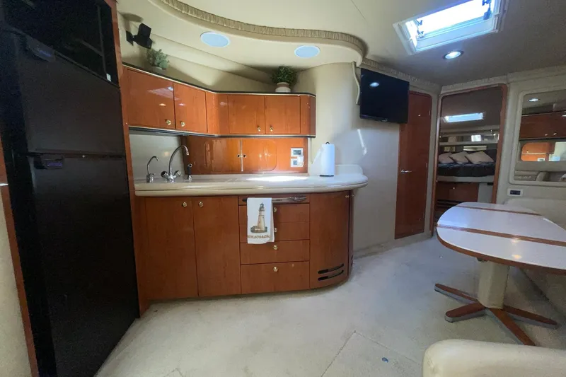Slide: The Image of Luxurious 1999 Sea Ray Sundancer 460 yacht interior with kitchenette and dining area. - 18