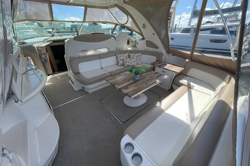 Slide: The Image of VERY NICELY UPDEATED AND CUSTOMIZED COCKPIT LOUNGE SEATING AREA WITH CUSOTM TABLES & STORAGE!! (OWNER ALSO HAS THE ORIGINAL SEA RAY TABLE AS WELL!!) - 5