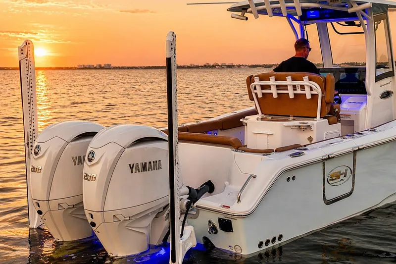 The Image of 2024 Sea Hunt Ultra 265 SE boat at sunset with dual Yamaha engines. - 0