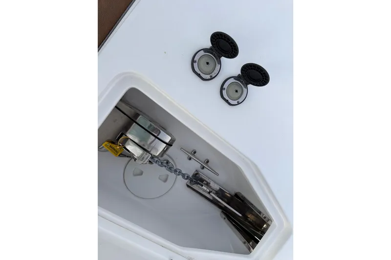Slide: The Image of Anchor compartment of 2024 Sea Hunt Ultra 265 SE boat with chain and fittings. - 15