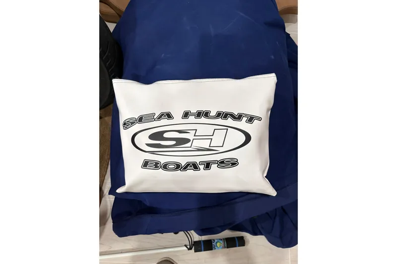 Slide: The Image of Cushion with Sea Hunt Boats logo on blue fabric, 2024 Ultra 265 SE model. - 20