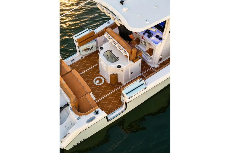 Slide: The Image of 2024 Sea Hunt Ultra 265 SE boat interior with tan seating and modern amenities. - 27
