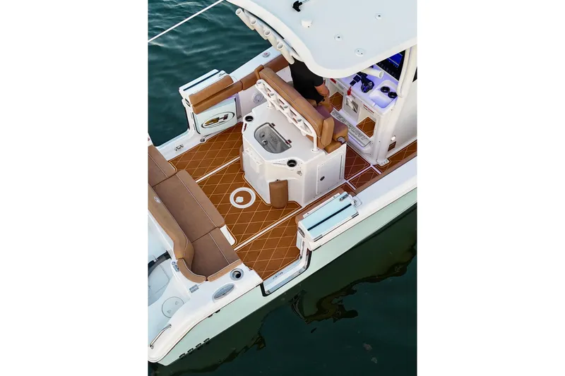 Slide: The Image of 2024 Sea Hunt Ultra 265 SE boat interior with brown seating and modern dashboard. - 28