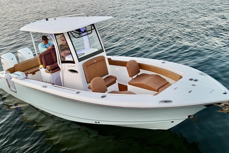 Slide: The Image of 2024 Sea Hunt Ultra 265 SE boat on water, featuring sleek design and comfortable seating. - 29