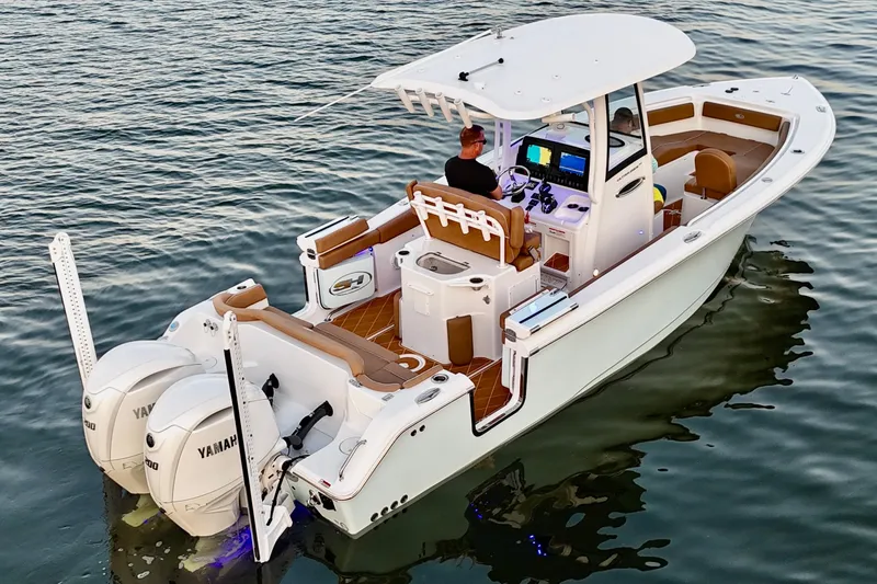 Slide: The Image of 2024 Sea Hunt Ultra 265 SE boat on water, featuring dual Yamaha engines. - 3