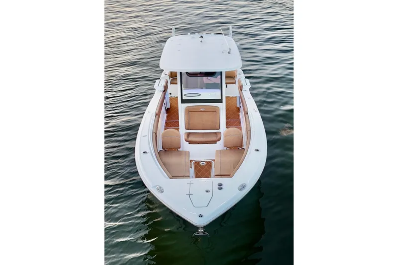 Slide: The Image of 2024 Sea Hunt Ultra 265 SE boat on water, showcasing sleek design and spacious seating. - 30