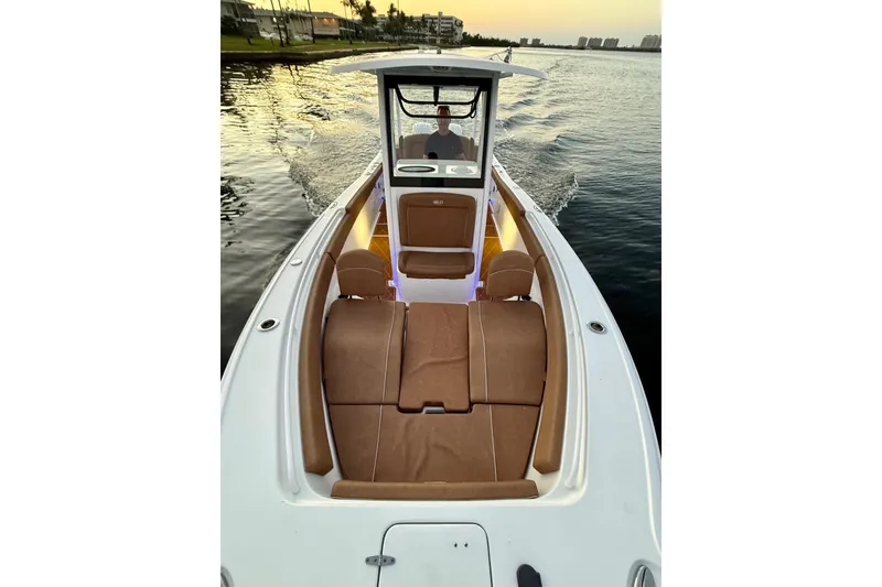 Slide: The Image of 2024 Sea Hunt Ultra 265 SE boat cruising on calm water at sunset. - 34