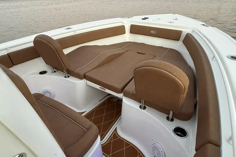 Slide: The Image of 2024 Sea Hunt Ultra 265 SE boat interior with brown cushioned seating and spacious layout. - 36