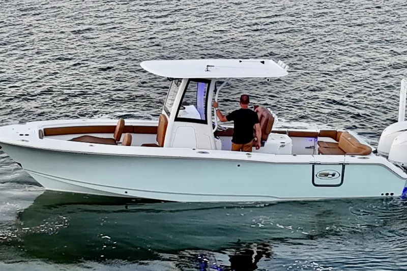 Slide: The Image of 2024 Sea Hunt Ultra 265 SE boat cruising on calm waters. - 37