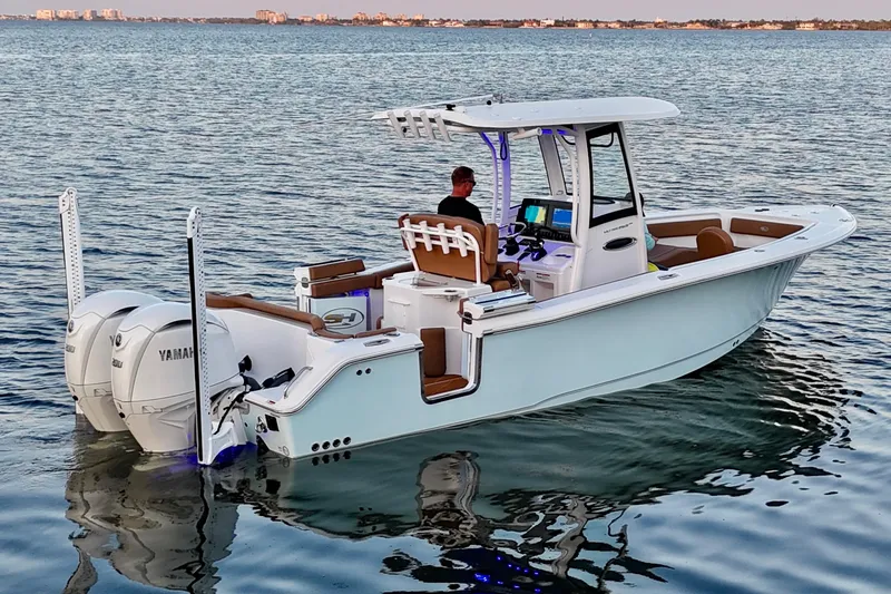 Slide: The Image of 2024 Sea Hunt Ultra 265 SE boat on calm water, featuring dual Yamaha engines. - 38