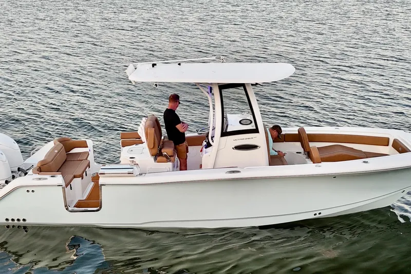 Slide: The Image of 2024 Sea Hunt Ultra 265 SE boat on water, featuring spacious seating and modern design. - 40